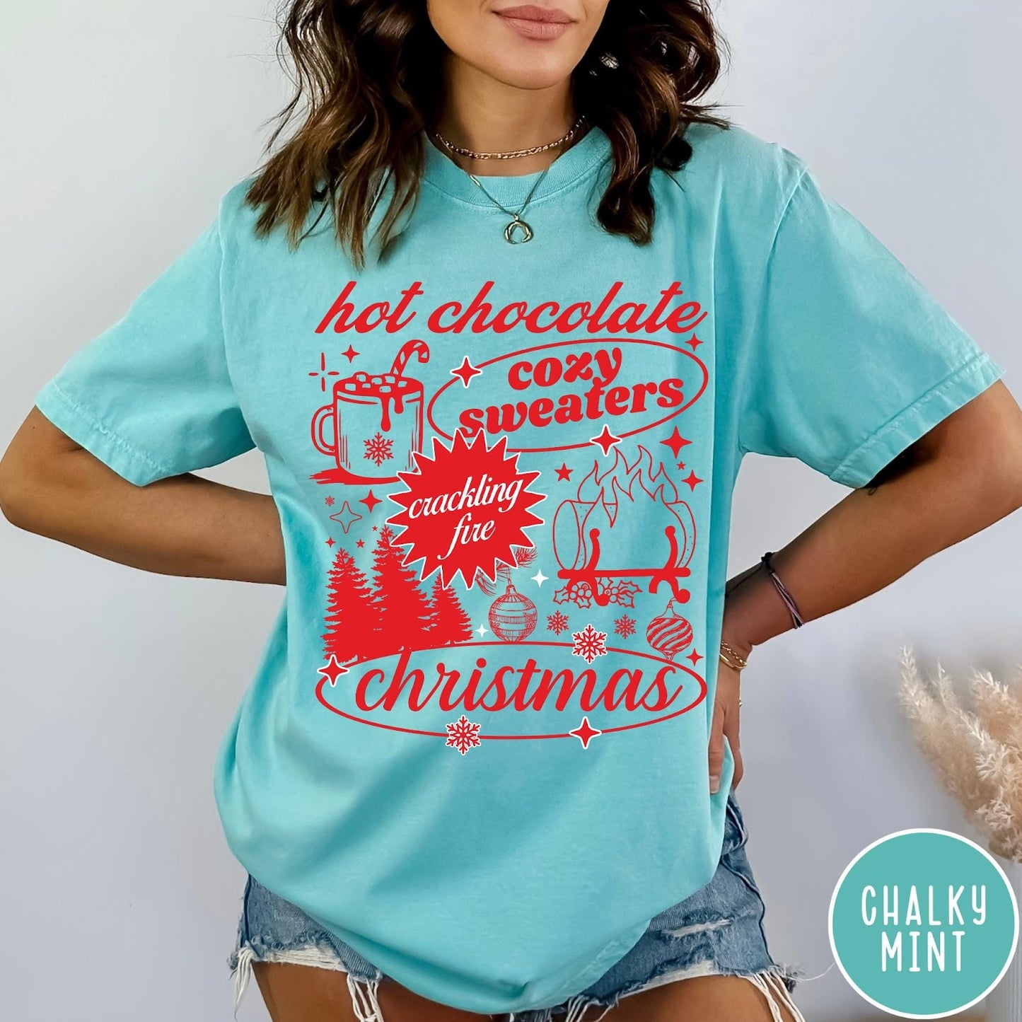 Comfort Colors tee in Chalky Mint featuring holiday graphic design with hot chocolate, fire, and Christmas trees