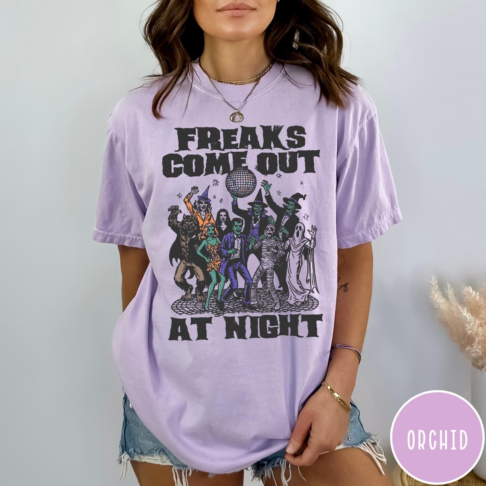 Comfort Colors tee in Orchid featuring retro disco style graphic of dancing monsters and a disco ball