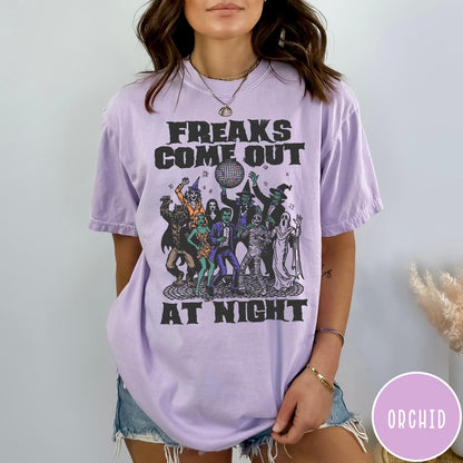 Comfort Colors tee in Orchid featuring retro disco style graphic of dancing monsters and a disco ball