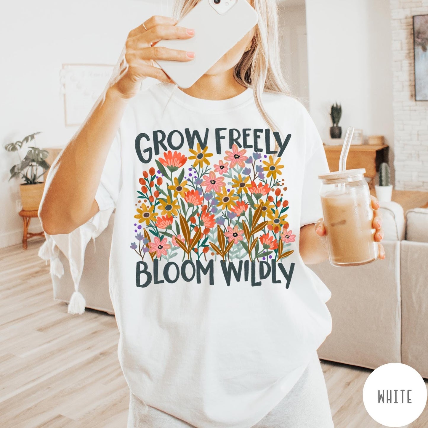Comfort Colors tee in White featuring wildflower design with text Grow Freely Bloom Wildly in earthy tones
