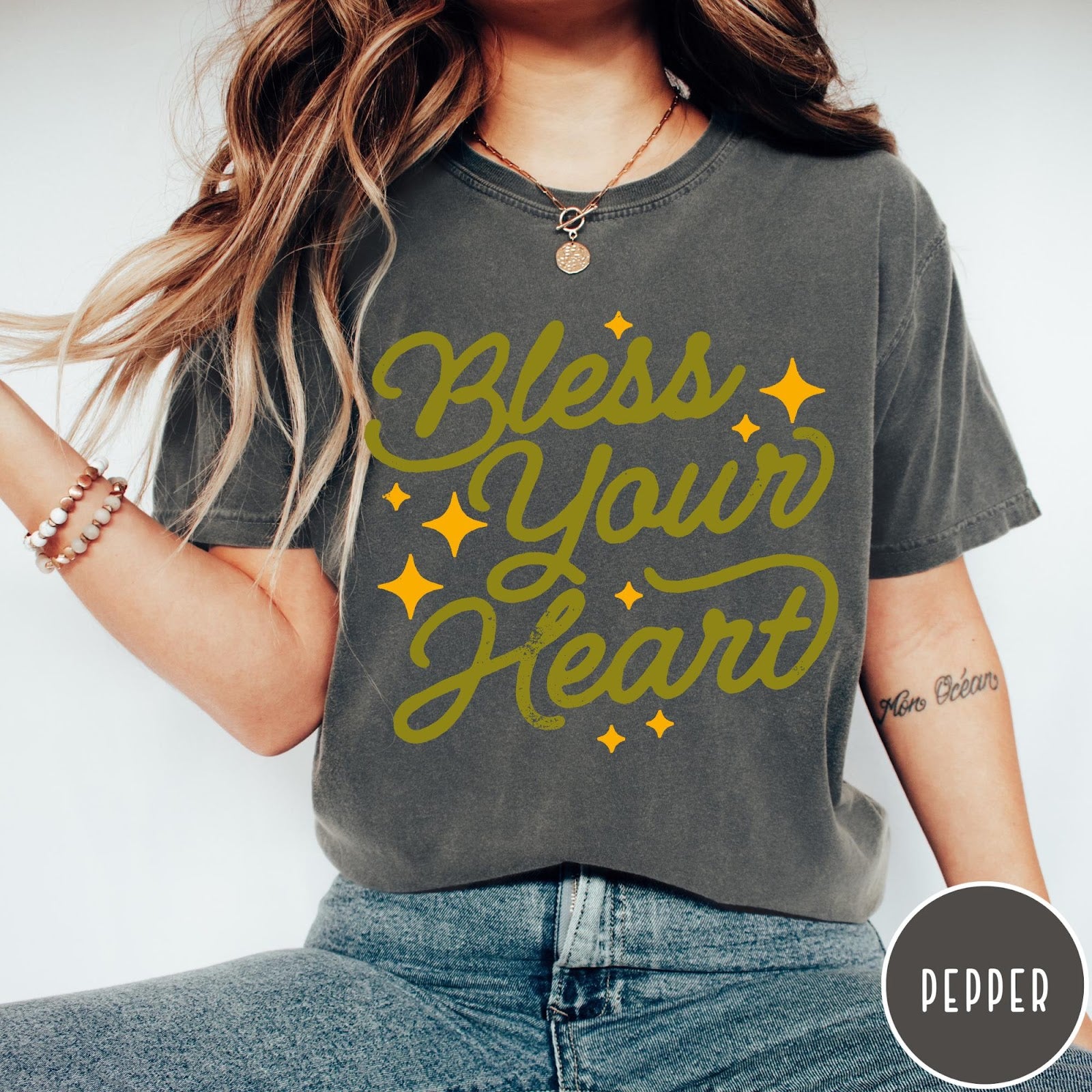 Comfort Colors tee in Pepper featuring script lettering and star accents with the phrase Bless Your Heart