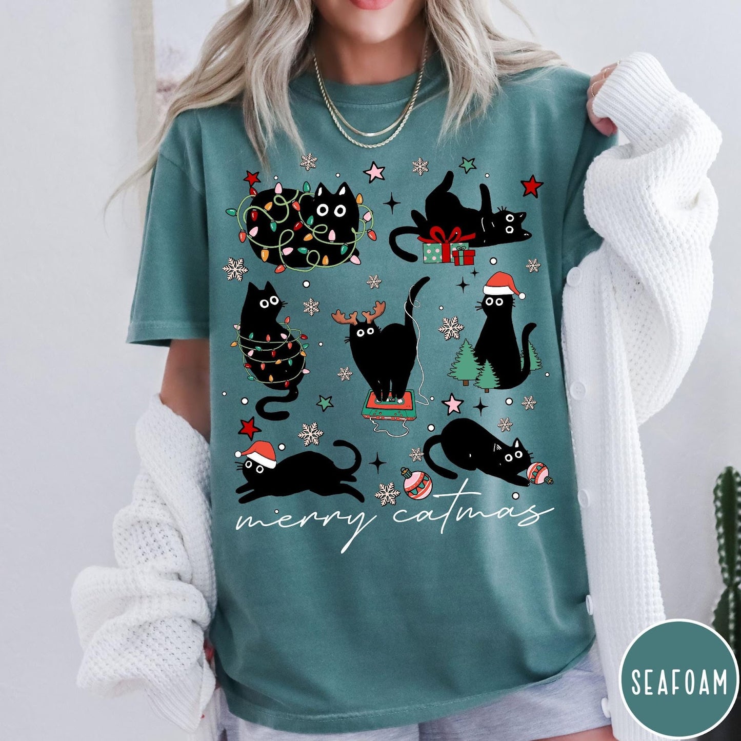 Comfort Colors tee in Seafoam featuring festive holiday graphic with multiple black cats and Christmas elements