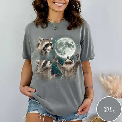 Comfort Colors tee in Gray featuring artistic graphic of three raccoons reaching toward a bright full moon