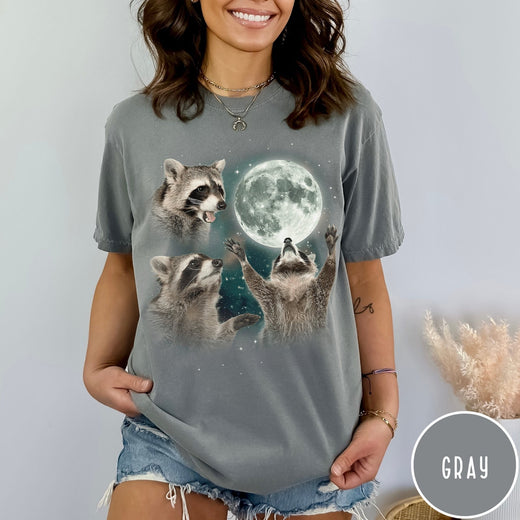 Comfort Colors tee in Gray featuring artistic graphic of three raccoons reaching toward a bright full moon