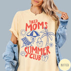 Comfort Colors tee in Butter featuring beach vacation style graphic with sun, umbrella, palm tree, and bag