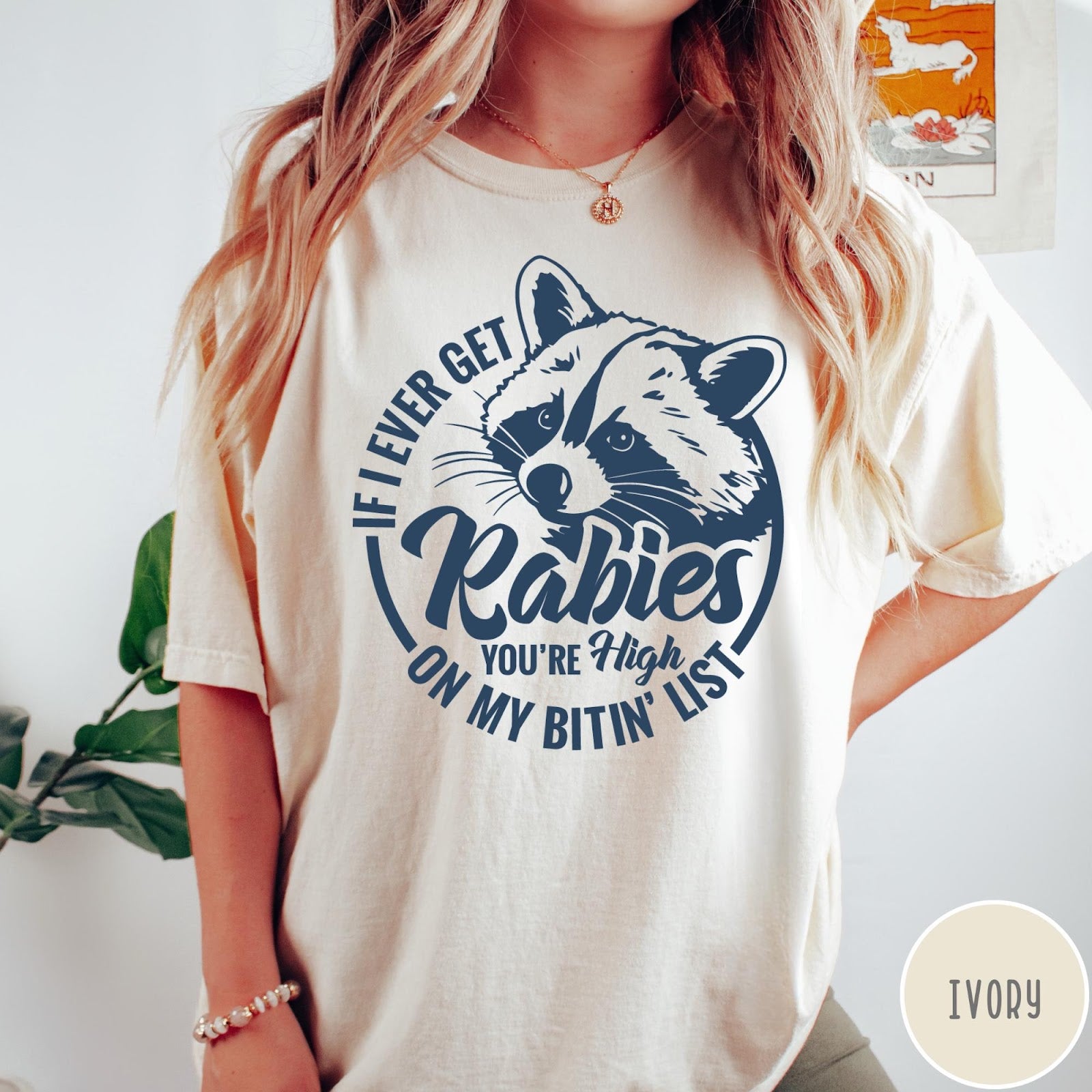 Comfort Colors tee in Ivory featuring screen print style graphic of a raccoon with funny rabies text