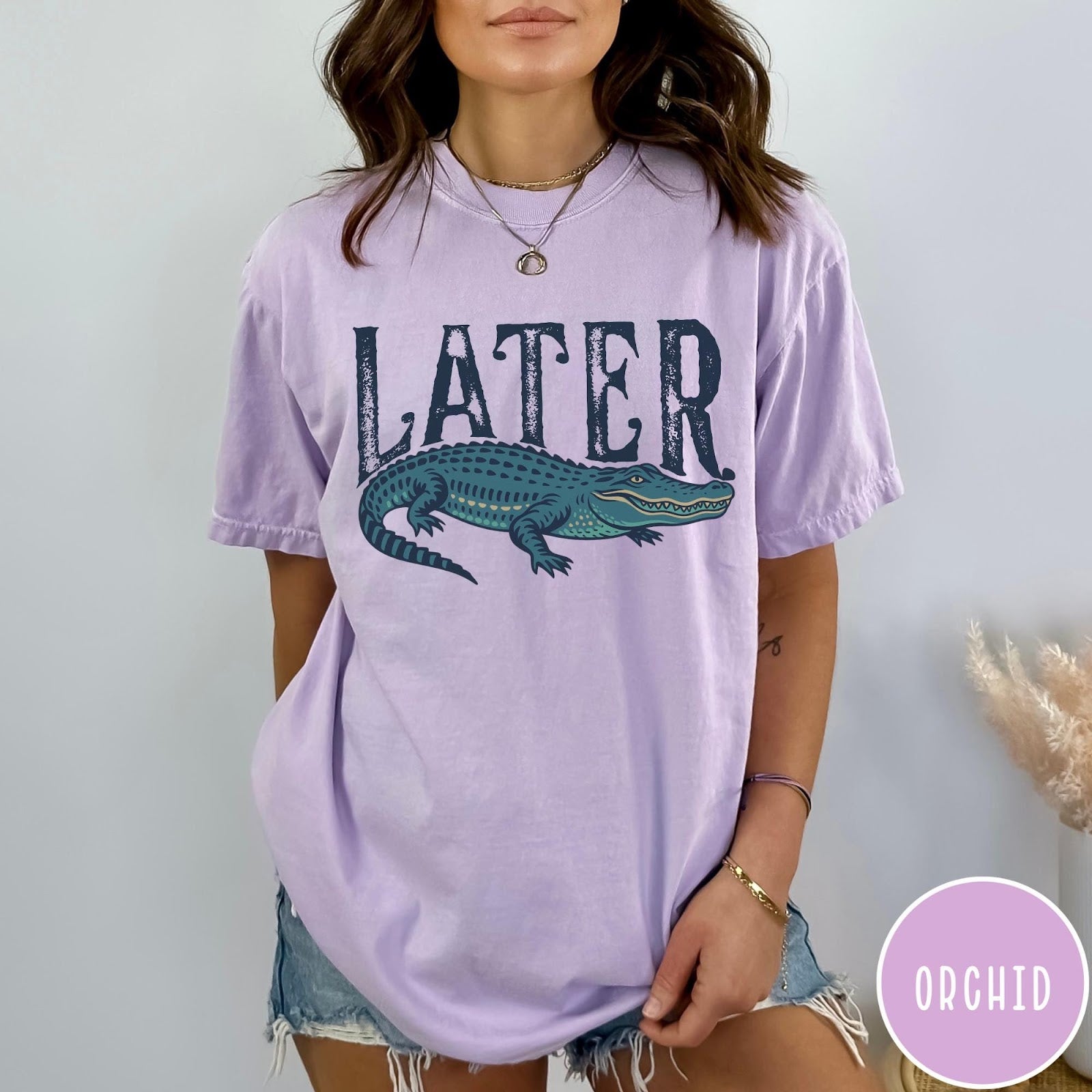 Comfort Colors tee in Orchid featuring casual style with a graphic of a green alligator and text