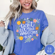 Comfort Colors tee in Flo Blue featuring floral design with mental health encouragement text Don't Let The Hard Days Win