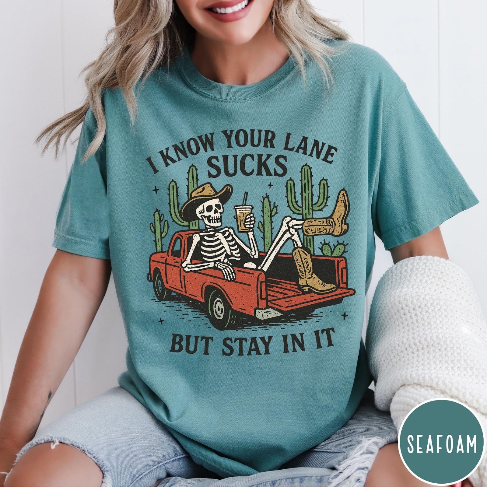 Comfort Colors tee in Seafoam featuring western skeleton design with cowboy hat and boots in truck bed