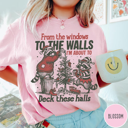 Comfort Colors tee in Blossom featuring vintage style graphic of two raccoons decorating a Christmas tree with trash