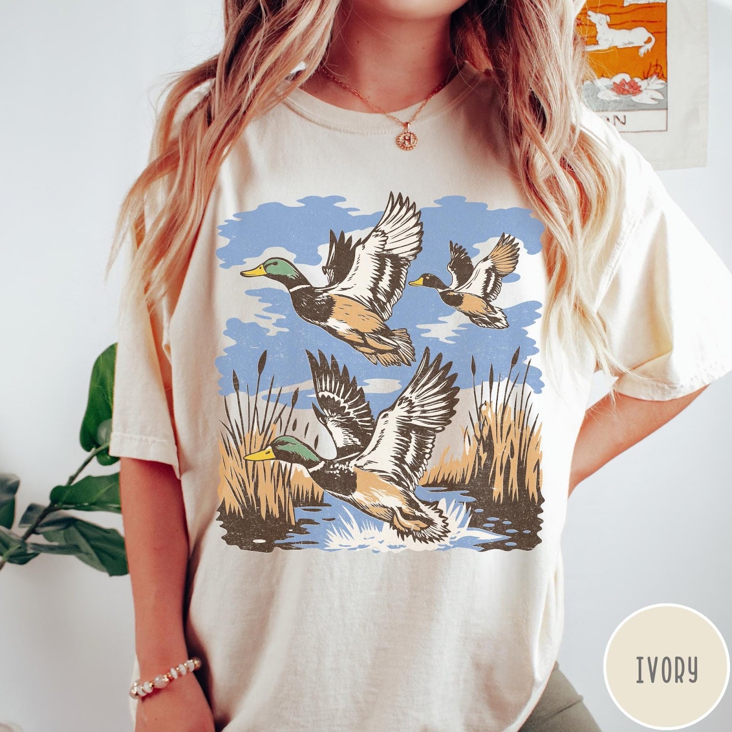 Comfort Colors tee in Ivory featuring vintage style mallard ducks flying over a marshy pond graphic