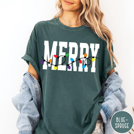 Comfort Colors tee in Blue Spruce featuring holiday style graphic with white Merry text and colorful Christmas lights