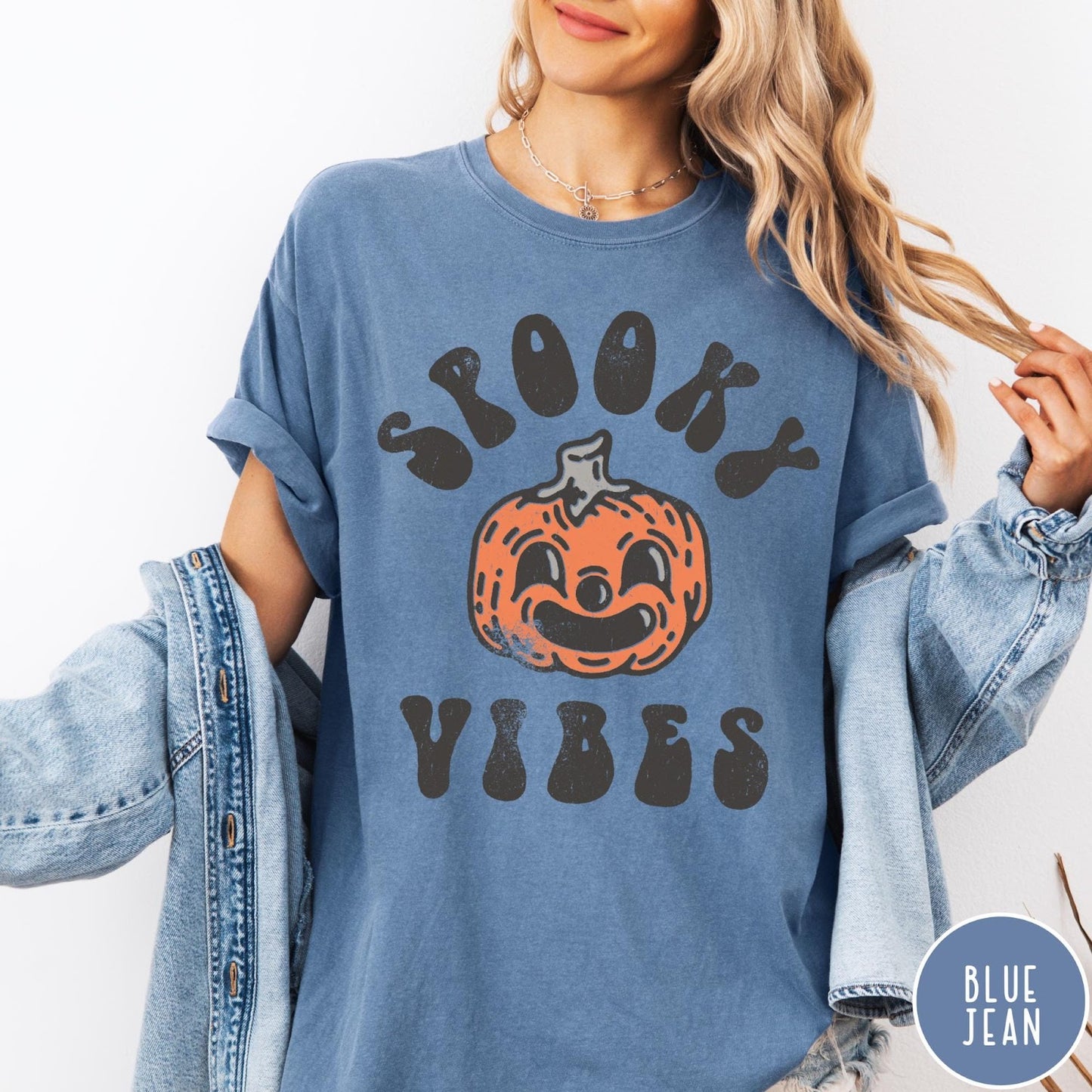 Comfort Colors tee in Blue Jean featuring retro style graphic with a smiling pumpkin and Spooky Vibes text