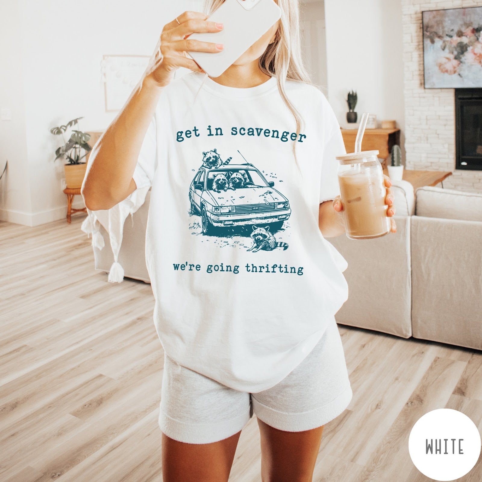 Comfort Colors tee in White featuring illustrated style graphic of raccoons riding in a car and thrifting