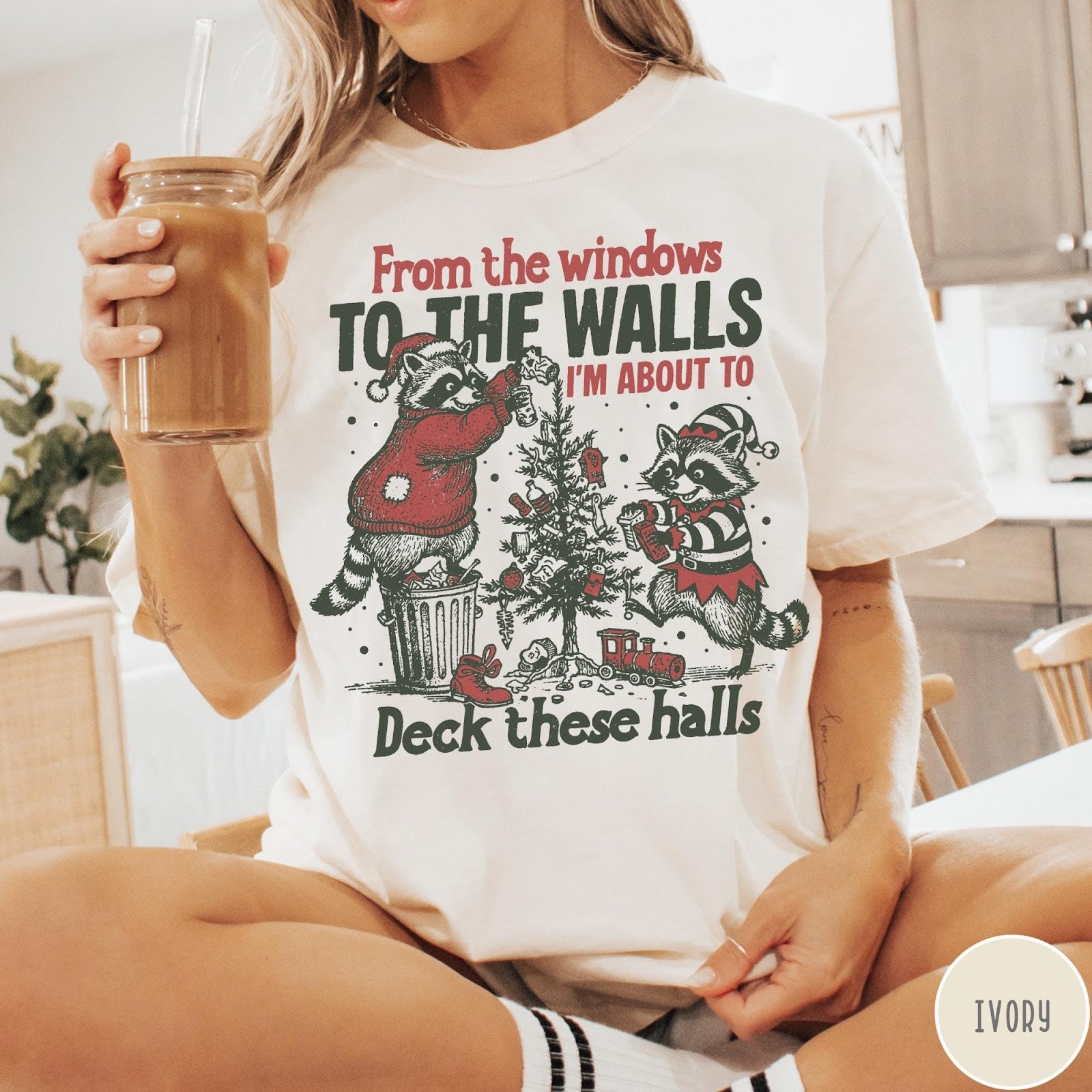 Comfort Colors tee in Ivory featuring vintage style graphic of two raccoons decorating a Christmas tree with trash