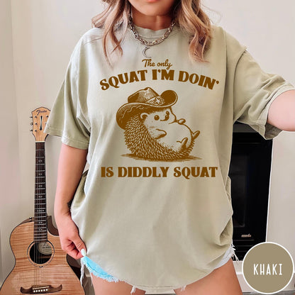 Comfort Colors tee in Khaki featuring cute graphic style illustration of a hedgehog wearing a cowboy hat