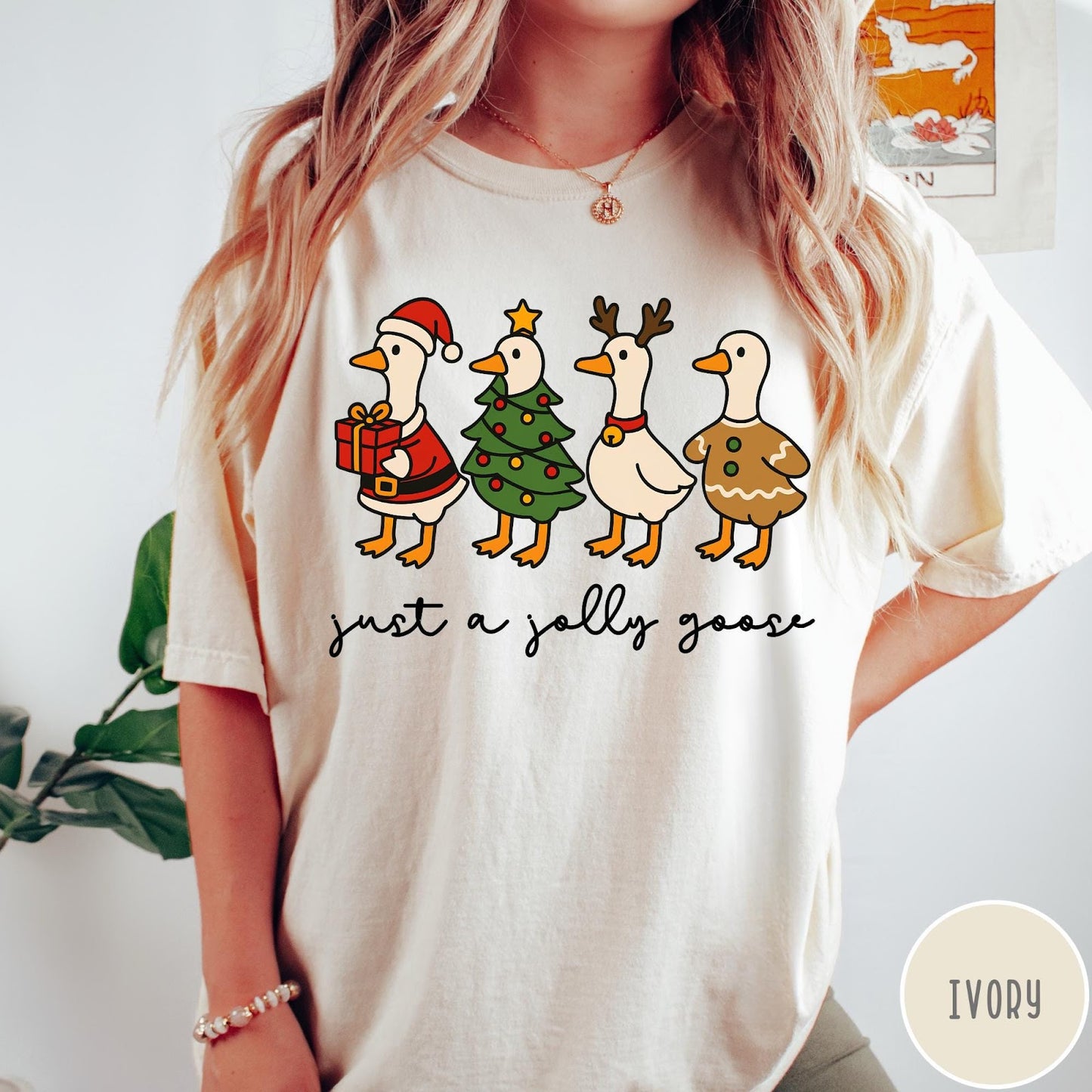 Comfort Colors tee in Ivory featuring festive geese graphic with Santa, Christmas tree, reindeer, and gingerbread goose designs