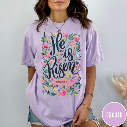 Comfort Colors tee in Orchid featuring Easter religious floral graphic with He is Risen and Luke 24:6-7 text