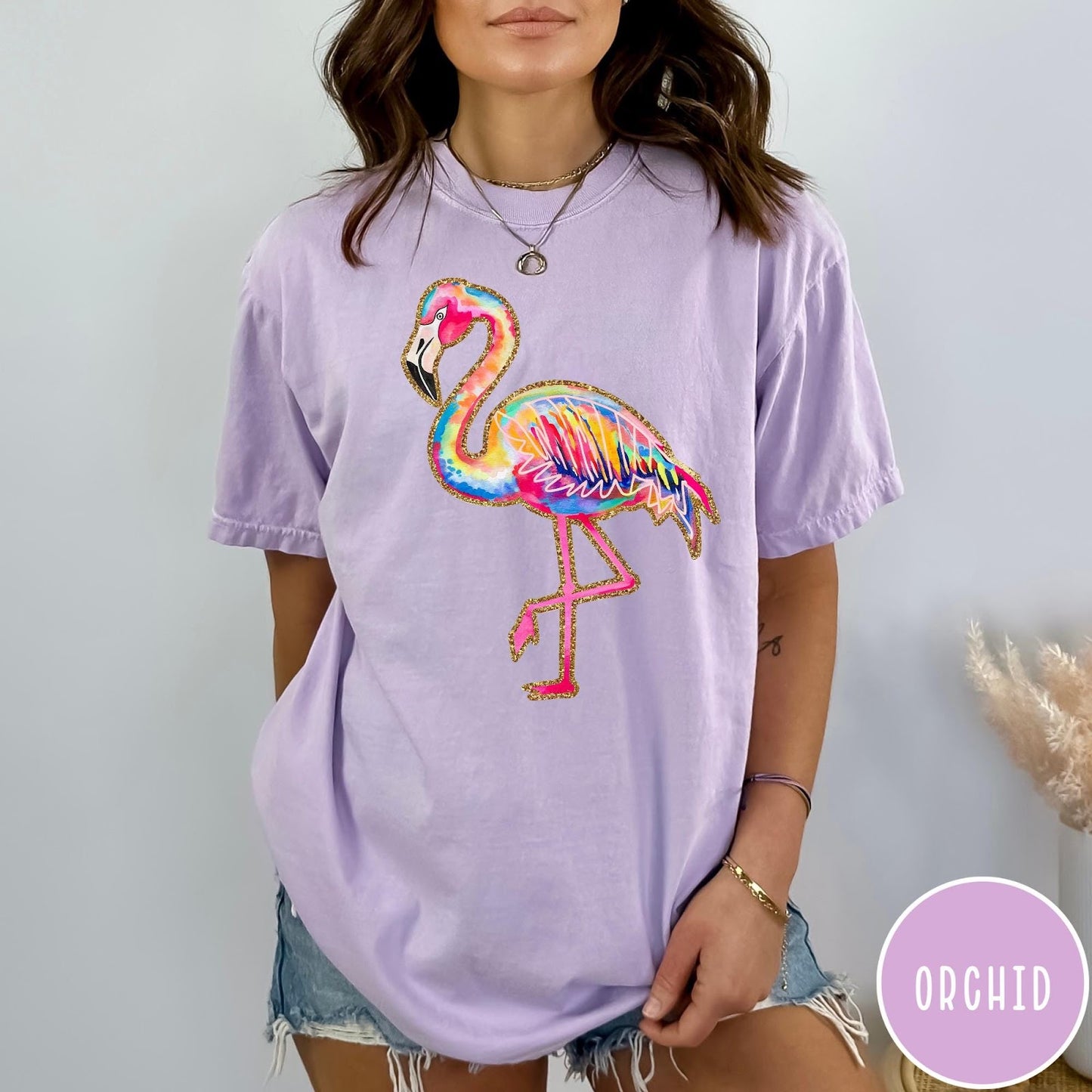 Comfort Colors tee in Orchid featuring artistic watercolor flamingo graphic with gold glitter outline details