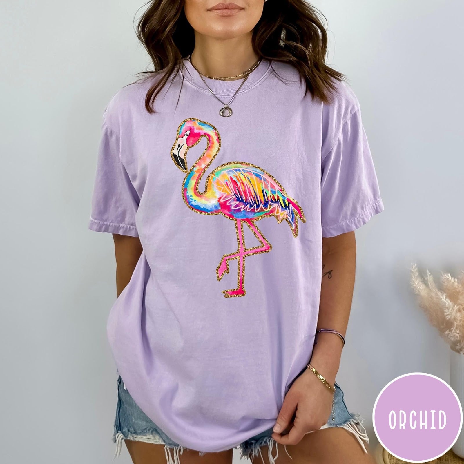 Comfort Colors tee in Orchid featuring artistic watercolor flamingo graphic with gold glitter outline details