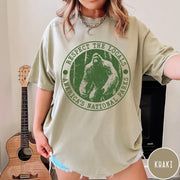 Comfort Colors tee in Khaki featuring circular graphic design with Bigfoot and Respect the Locals text