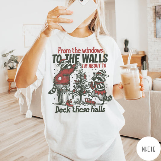 Comfort Colors tee in Ivory featuring vintage line illustration of two raccoons decorating a Christmas tree with trash.