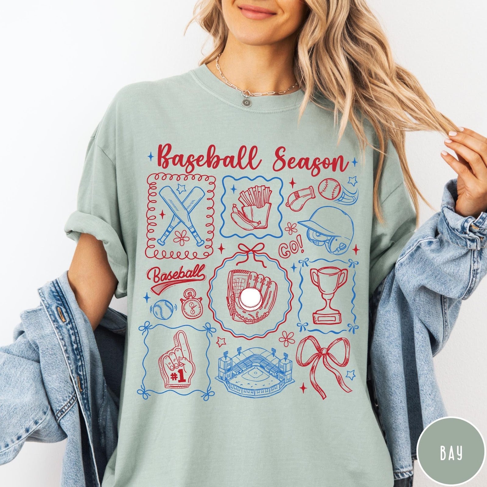 Comfort Colors tee in Bay featuring baseball icons including bats, a glove, stadium, and trophy graphic design