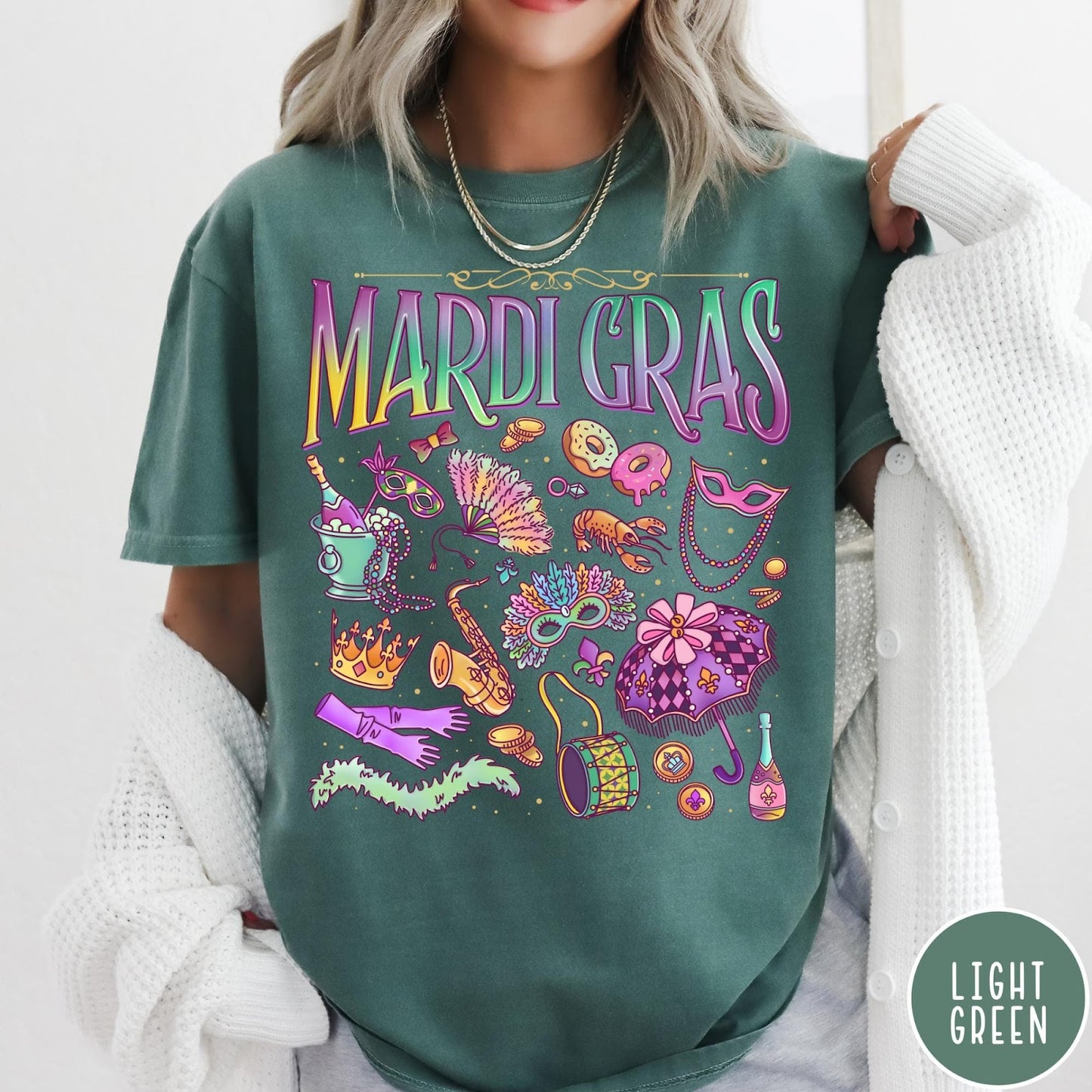 Comfort Colors tee in Light Green featuring vintage style Mardi Gras celebration icons including masks, beads, and saxophone