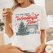 Comfort Colors tee in Ivory featuring Christmas design with a decorated tree and a cozy fireplace scene