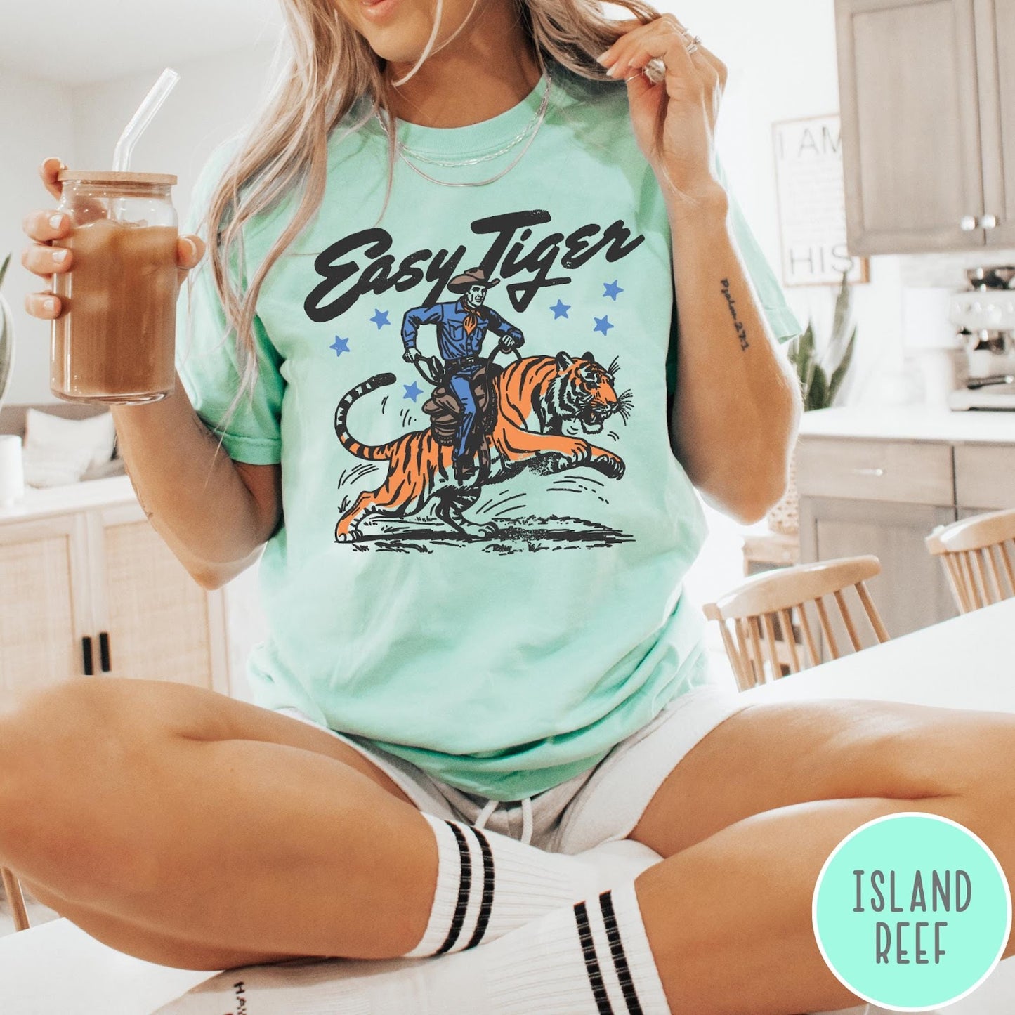 Comfort Colors tee in Island Reef featuring western graphic style cowboy riding a tiger with blue stars