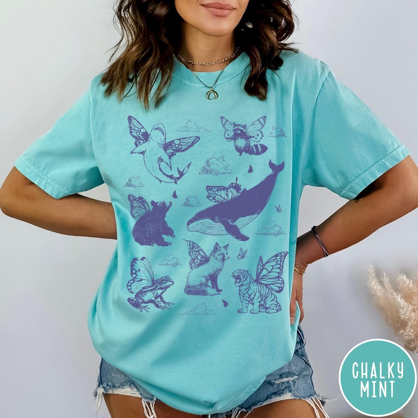 Comfort Colors tee in Chalky Mint featuring vintage style graphic of various animals with butterfly wings and clouds