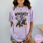 Comfort Colors tee in Orchid featuring vintage style graphic of a woman riding a bear holding whiskey