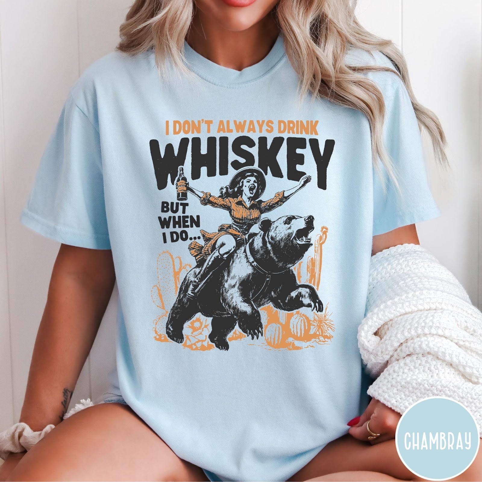 Comfort Colors tee in Chambray featuring vintage style graphic of a woman riding a bear holding whiskey