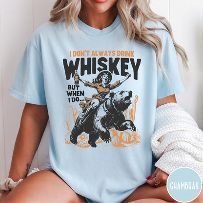 Comfort Colors tee in Chambray featuring vintage style graphic of a woman riding a bear holding whiskey
