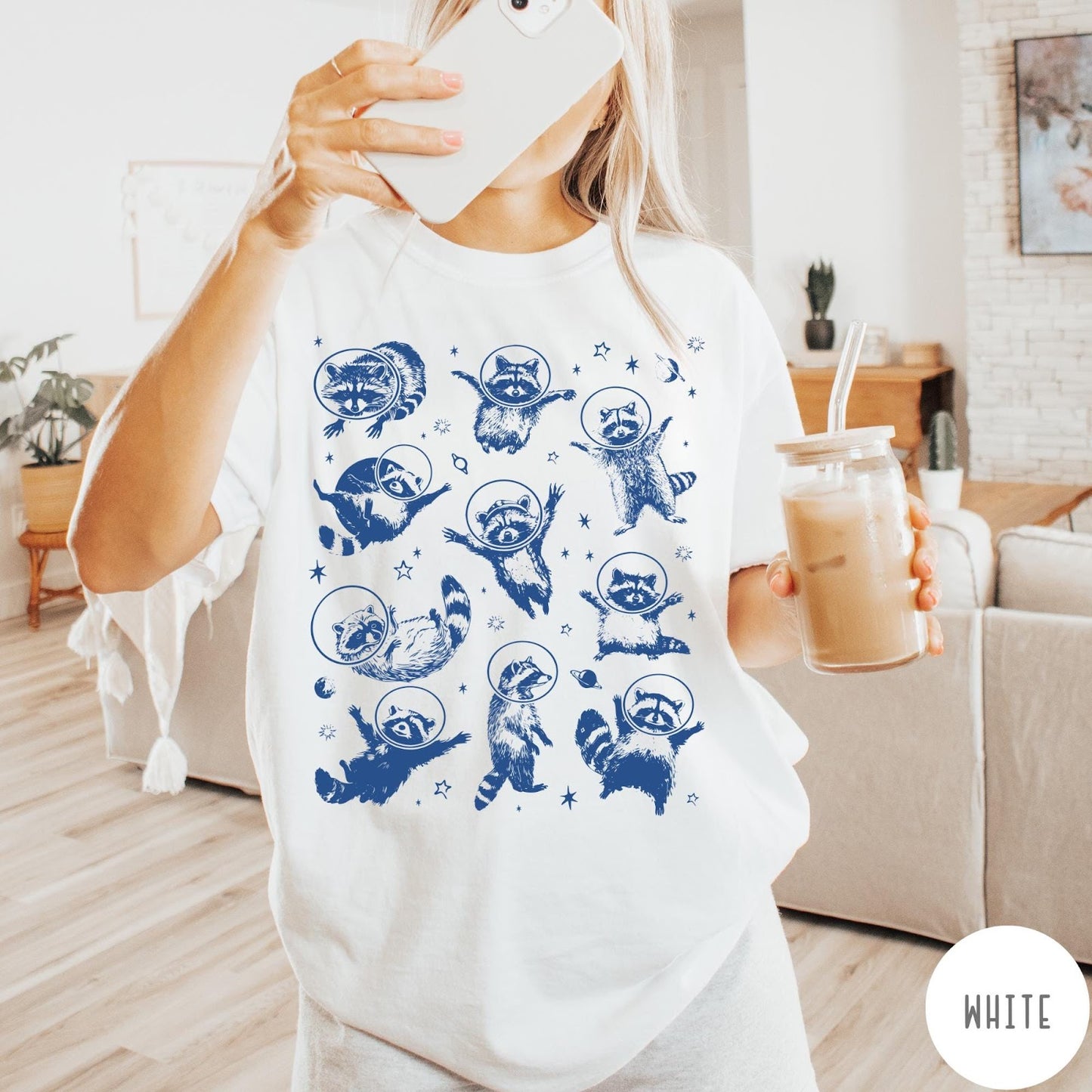 Comfort Colors tee in White featuring whimsical space design with multiple raccoons wearing glass astronaut helmets and stars