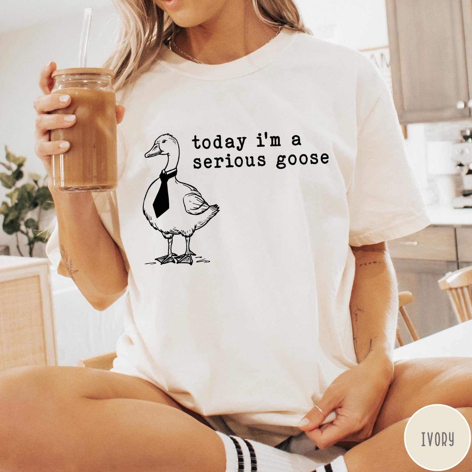 Comfort Colors tee in Ivory featuring minimalist graphic design of a goose wearing a necktie and text