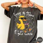 Comfort Colors tee in Pepper featuring illustrated duck graphic wearing sunglasses and drinking a pink iced beverage