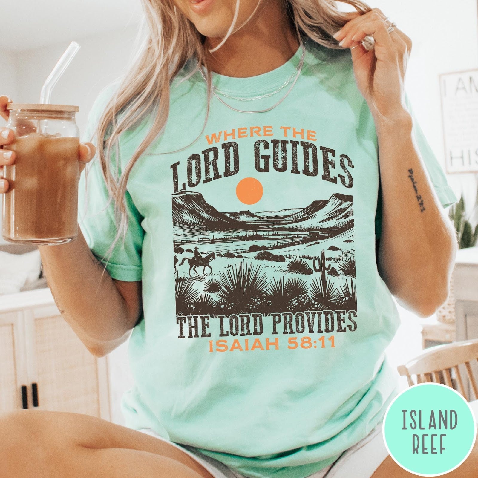 Comfort Colors tee in Island Reef featuring desert landscape graphic with a rider and sun design.