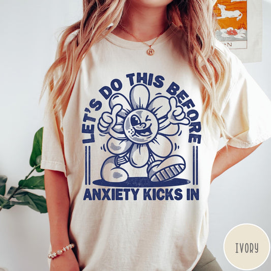 Comfort Colors tee in Ivory featuring retro graphic style winking flower character with anxiety text design
