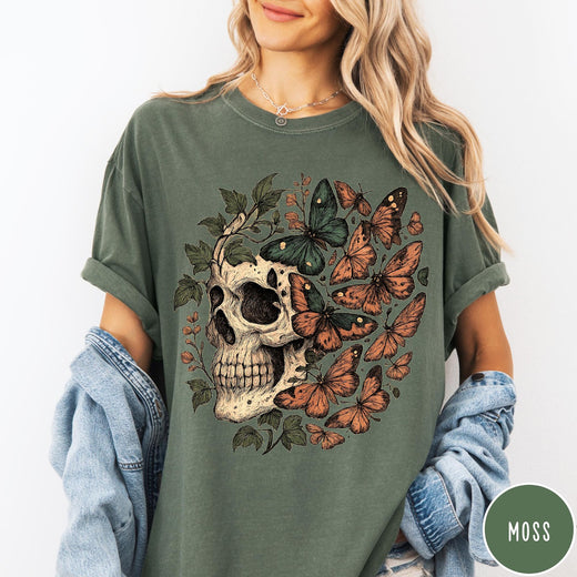 Comfort Colors tee in Moss featuring vintage style graphic with a skull surrounded by various colorful butterflies