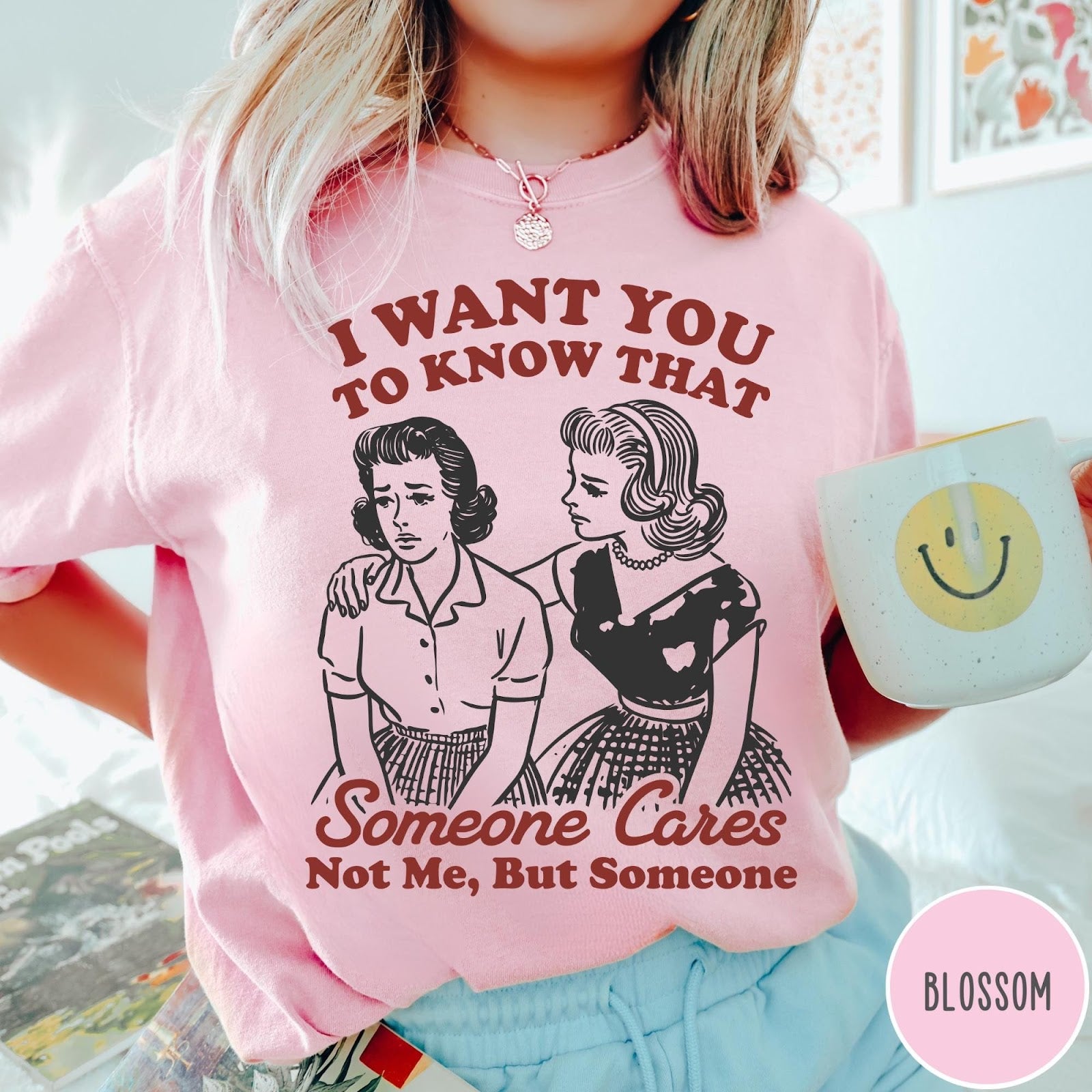 Comfort Colors tee in Blossom featuring vintage style graphic of two women comforting each other with text