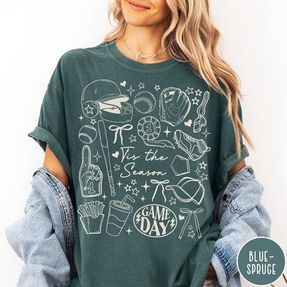 Comfort Colors tee in Blue Spruce featuring baseball game day graphic with helmet, bat, ball, and snacks.