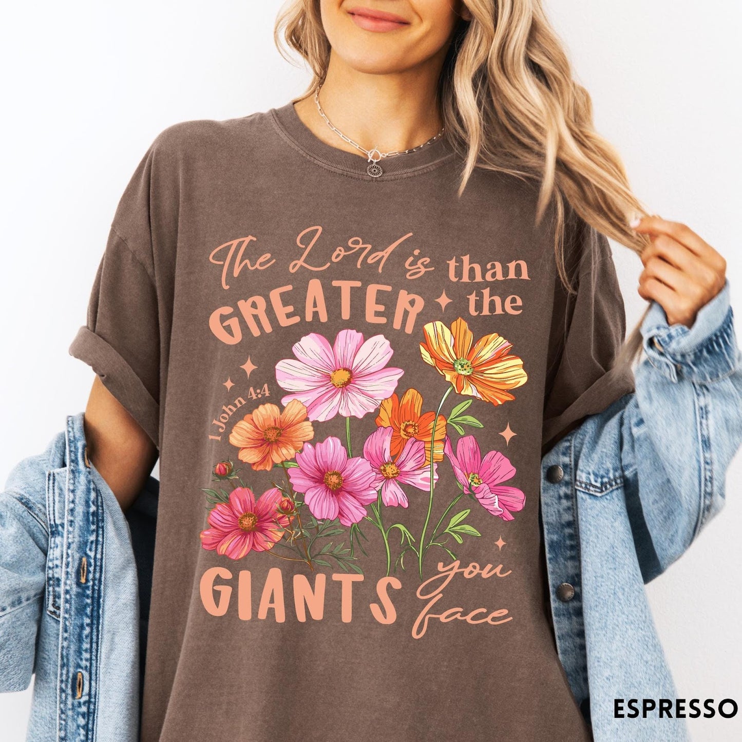 Comfort Colors tee in Espresso featuring floral Bible verse graphic design with 1 John 4:4 scripture text