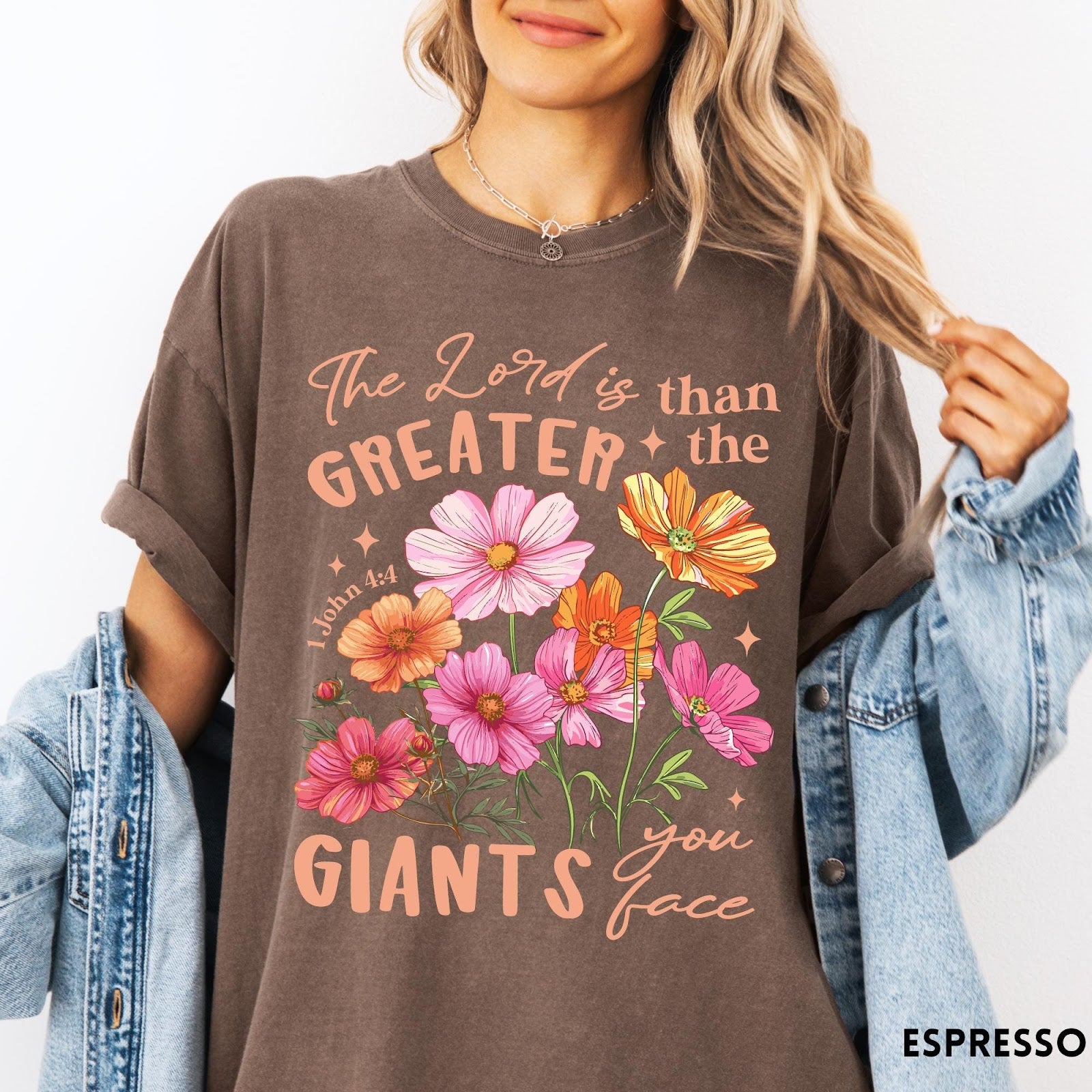 Comfort Colors tee in Espresso featuring floral Bible verse graphic design with 1 John 4:4 scripture text