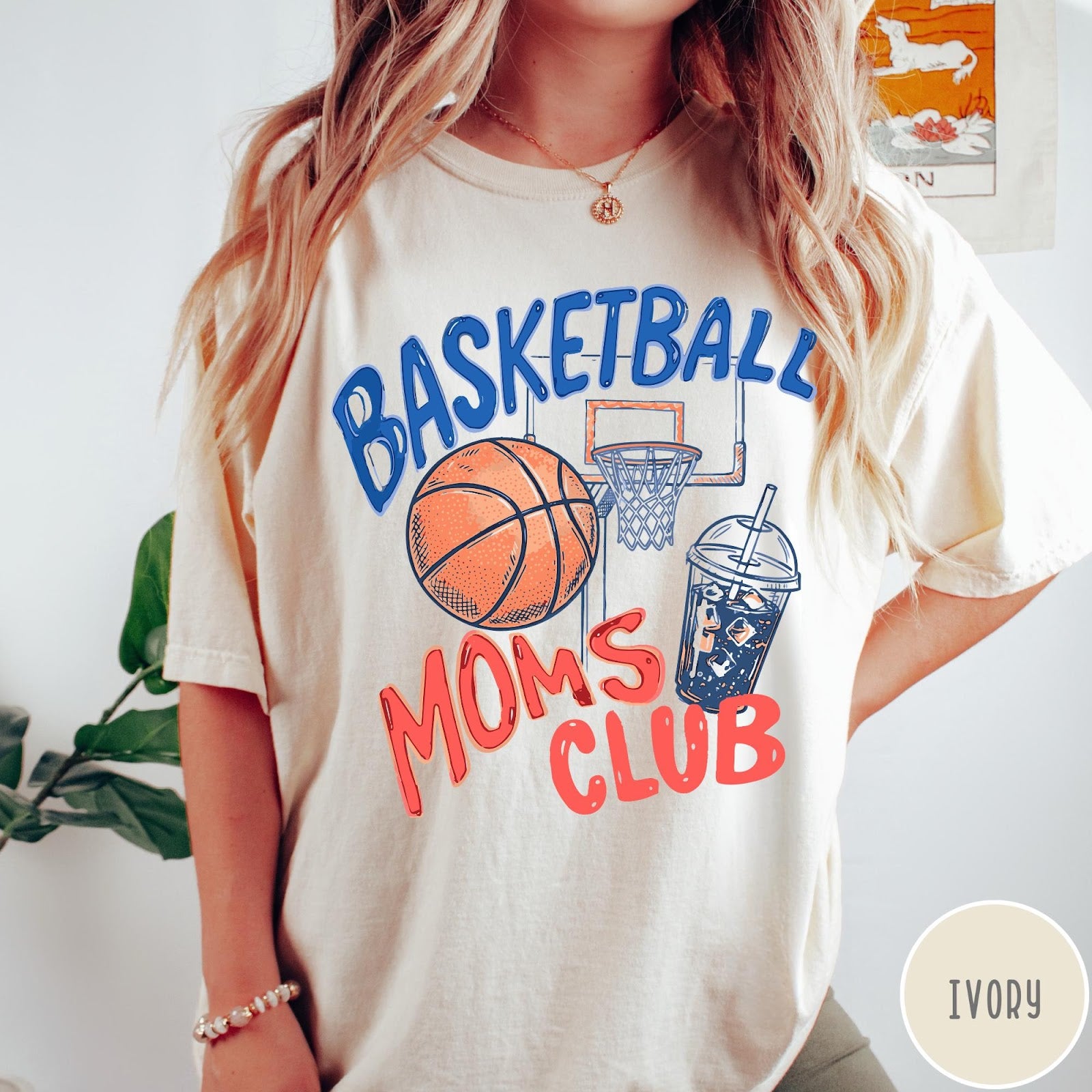 Comfort Colors tee in Ivory featuring basketball mom life graphic with basketball, hoop, and iced coffee drink