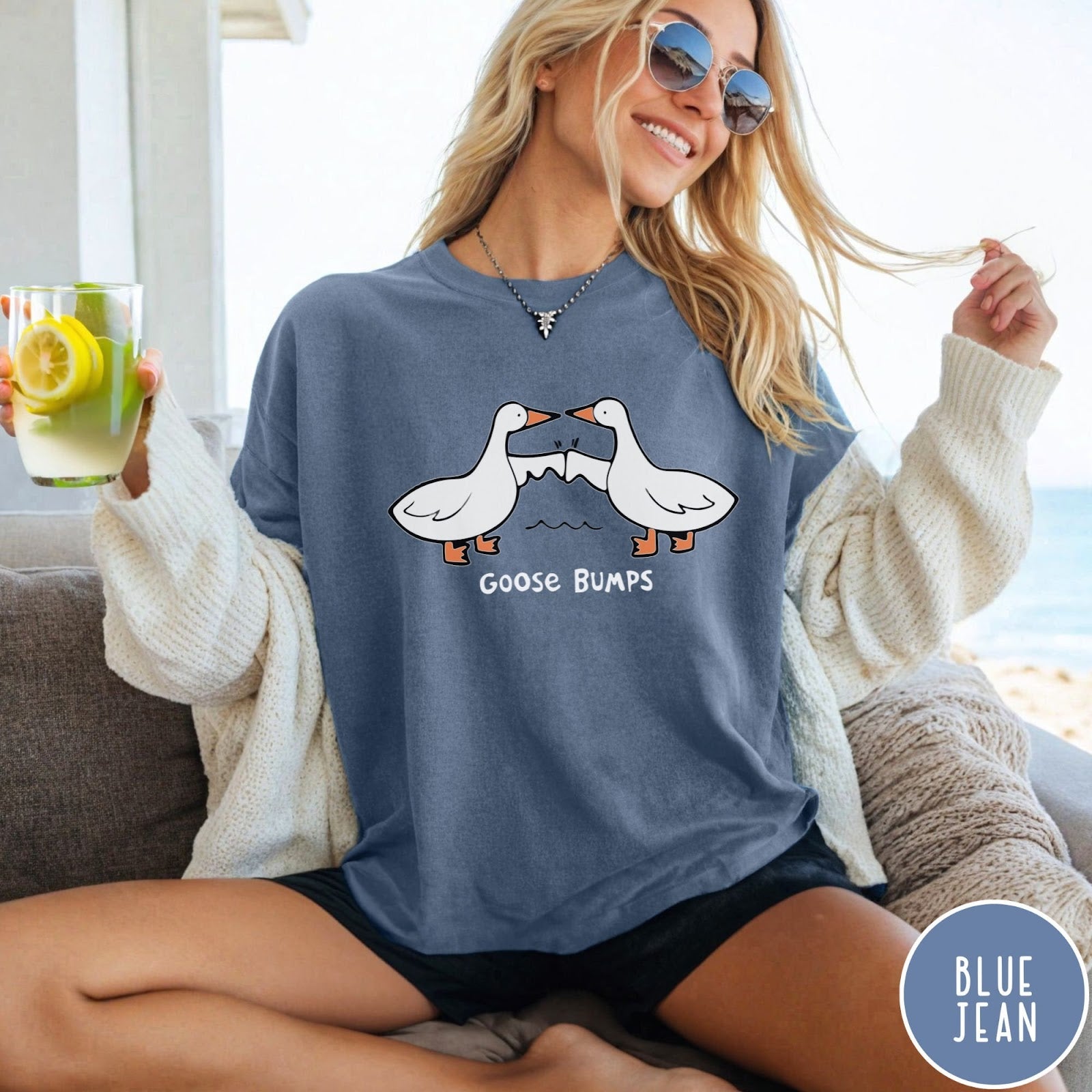 Comfort Colors tee in Blue Jean featuring cartoon style graphic of two geese giving each other a fist bump