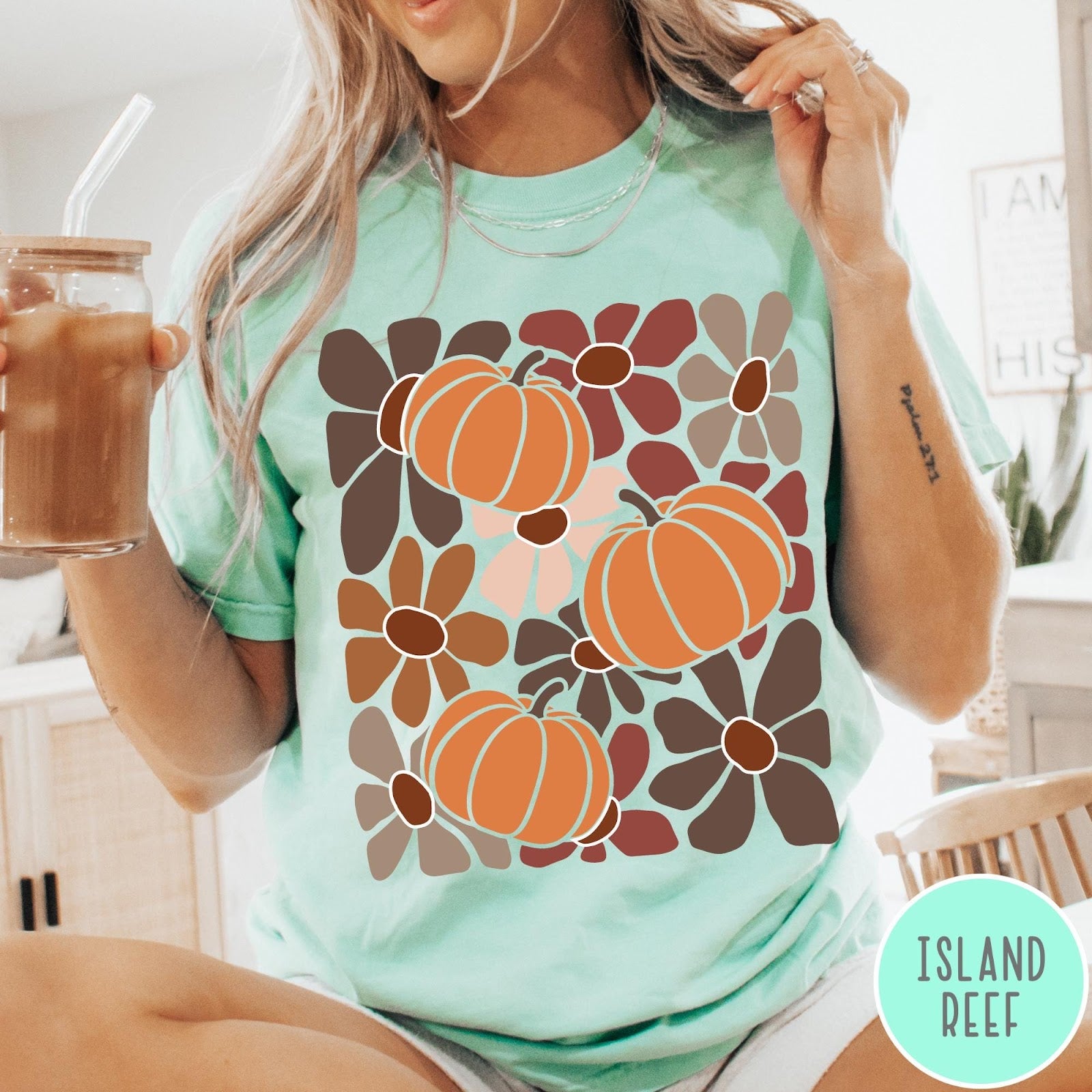 Comfort Colors tee in Island Reef featuring boho floral style graphic with three orange pumpkins and brown flowers