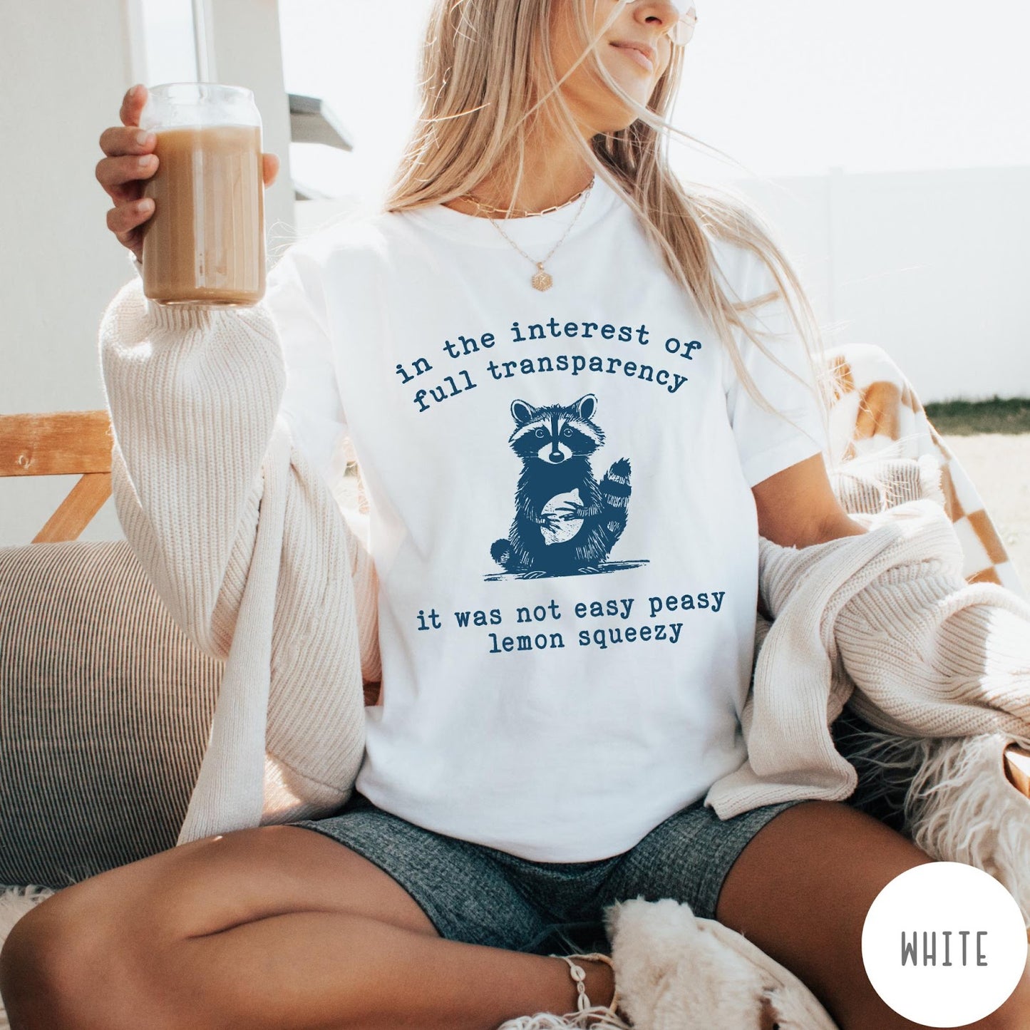 Comfort Colors tee in White featuring screen printed raccoon graphic and text about full transparency and lemons