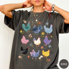 Comfort Colors tee in Pepper featuring vintage style graphic with various colorful chickens and small floral accents