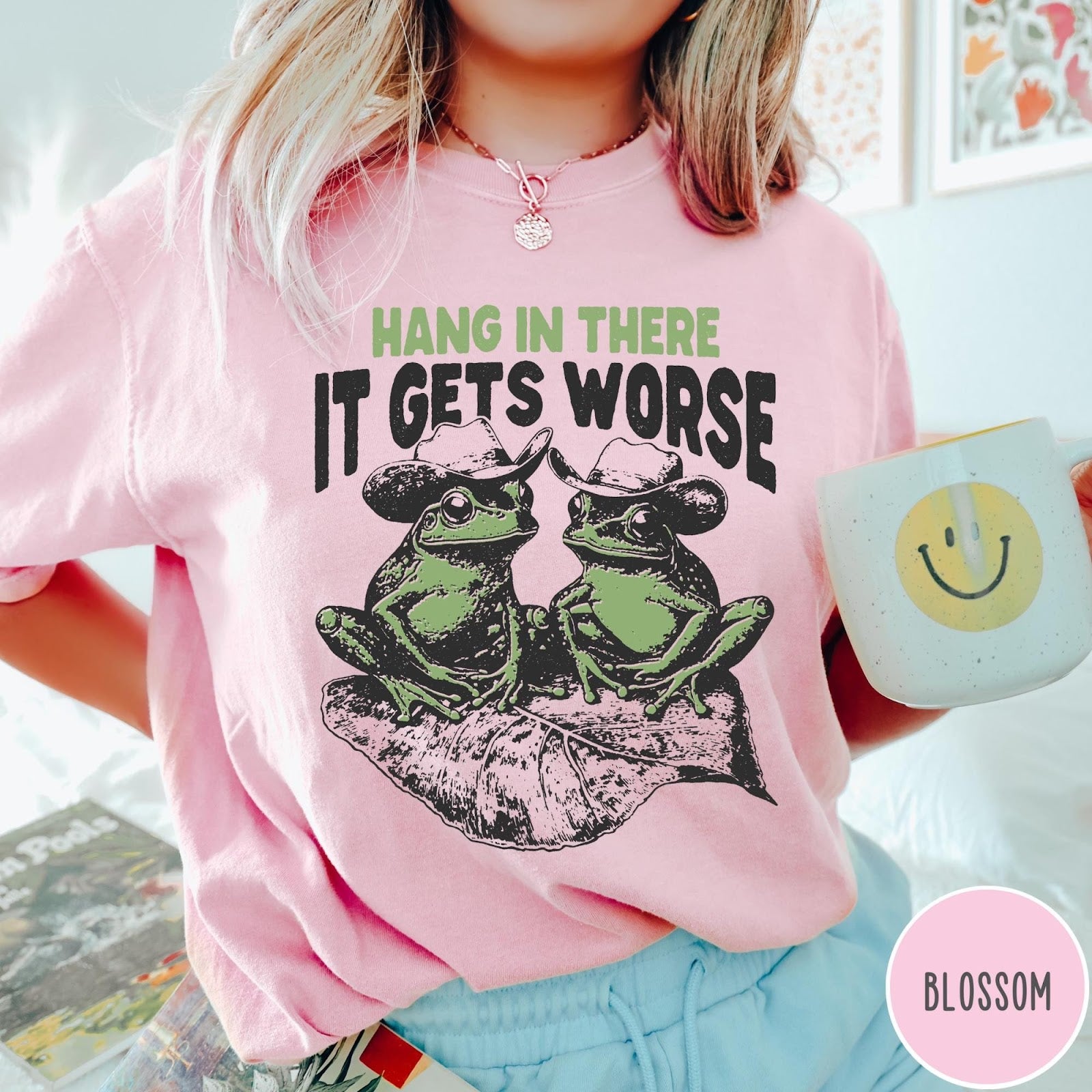 Comfort Colors tee in Blossom featuring vintage style graphic of two frogs wearing cowboy hats on leaf